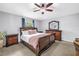 Comfortable bedroom featuring a ceiling fan, lush carpet and wood furniture at 3162 27Th E Ct, Palmetto, FL 34221
