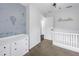 Bedroom featuring decor on a light blue accent wall, crib and changing table at 3162 27Th E Ct, Palmetto, FL 34221