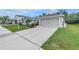 The property features a long concrete driveway leading to an attached two-car garage and a landscaped front yard at 3162 27Th E Ct, Palmetto, FL 34221