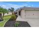 Inviting front exterior of a home with lovely landscaping and an attached two-car garage at 3162 27Th E Ct, Palmetto, FL 34221
