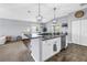 Open-concept kitchen with an island, stainless steel appliances, and a view of the dining and living areas at 3162 27Th E Ct, Palmetto, FL 34221