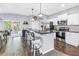 Stylish kitchen featuring modern appliances, barstool seating, and open access to a screened patio at 3162 27Th E Ct, Palmetto, FL 34221