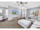 Inviting living room boasts a cozy sectional sofa, ceiling fan, and a view of the kitchen at 3162 27Th E Ct, Palmetto, FL 34221