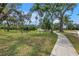 Scenic park featuring a paved pathway, lush green lawn, and mature trees providing ample shade at 3162 27Th E Ct, Palmetto, FL 34221