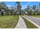 Beautiful park featuring a winding sidewalk, mature trees, and lush greenery, perfect for a stroll at 3162 27Th E Ct, Palmetto, FL 34221
