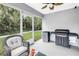 Cozy screened patio featuring a mini fridge and a Blackstone grill for outdoor entertaining at 3162 27Th E Ct, Palmetto, FL 34221