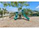Community playground featuring slides, climbing structures, and a soft wood chip ground for safety at 3162 27Th E Ct, Palmetto, FL 34221