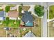 Aerial view of the property showcasing the fenced backyard, swimming pool, and lush landscaping at 3808 Cape Vista Dr, Bradenton, FL 34209