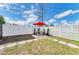 White fenced back yard with picnic table, seating area and pavers at 3808 Cape Vista Dr, Bradenton, FL 34209