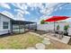 Fenced back yard with pool, picnic table, and a patio at 3808 Cape Vista Dr, Bradenton, FL 34209
