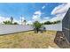 Back yard with a small seating area with black chairs and a fire pit at 3808 Cape Vista Dr, Bradenton, FL 34209