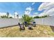 Cozy backyard retreat with blue Adirondack chairs and a fire pit, enclosed by a white privacy fence at 3808 Cape Vista Dr, Bradenton, FL 34209