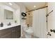 Stylish bathroom with a modern vanity, neutral-tiled shower, and sleek black fixtures at 3808 Cape Vista Dr, Bradenton, FL 34209