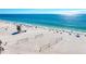 Wide sandy beach with volleyball nets and lifeguard tower at 3808 Cape Vista Dr, Bradenton, FL 34209