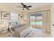 Cozy bedroom with a ceiling fan and sliding glass doors leading to a refreshing pool view at 3808 Cape Vista Dr, Bradenton, FL 34209