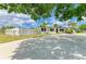 Attractive single-story home with a spacious driveway, white picket fence, and lush tropical landscaping at 3808 Cape Vista Dr, Bradenton, FL 34209