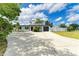Lovely single-Gathering home showcasing a circular driveway, mature palms, and a well-manicured lawn at 3808 Cape Vista Dr, Bradenton, FL 34209