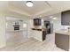 Open-concept kitchen with stainless steel appliances and granite counters, with easy access to living room at 3808 Cape Vista Dr, Bradenton, FL 34209