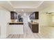 Well-lit kitchen with granite countertops, ample dark wood cabinetry, and stainless steel appliances at 3808 Cape Vista Dr, Bradenton, FL 34209