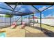 Screened in pool patio featuring lounge chairs, outdoor seating, and a well-maintained fence line at 3808 Cape Vista Dr, Bradenton, FL 34209