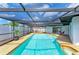 Large enclosed swimming pool with lounge chairs and seating at 3808 Cape Vista Dr, Bradenton, FL 34209