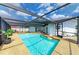 Enclosed swimming pool with lounge chairs, and a patio at 3808 Cape Vista Dr, Bradenton, FL 34209