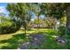 Lush backyard with mature trees and green lawn offering a serene and spacious outdoor environment at 3988 Berlin Dr, Sarasota, FL 34233