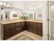 Spacious bathroom featuring double sinks, granite counters, and ample cabinet space at 3988 Berlin Dr, Sarasota, FL 34233