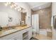 Bathroom with a granite vanity top, framed mirror, and a tub-shower combo at 3988 Berlin Dr, Sarasota, FL 34233