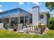 Exterior view of home showcasing a screened-in lanai and balustrade, providing outdoor living space and architectural detail at 3988 Berlin Dr, Sarasota, FL 34233