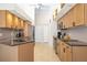 Well-equipped kitchen features stainless steel appliances, light wood cabinets, and tiled floors at 3988 Berlin Dr, Sarasota, FL 34233