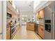 Well-equipped kitchen features stainless steel appliances, light wood cabinets, and tiled floors at 3988 Berlin Dr, Sarasota, FL 34233