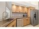 Kitchen featuring stainless steel appliances, light wood cabinets, and tiled backsplash at 3988 Berlin Dr, Sarasota, FL 34233
