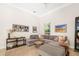 Bright living room with a large sectional sofa, accent pillows, and stylish decor at 3988 Berlin Dr, Sarasota, FL 34233