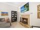 Cozy living room featuring a stone fireplace, flat-screen TV, and comfortable seating at 3988 Berlin Dr, Sarasota, FL 34233