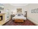 Bright bedroom with a rug, seating, white walls, and a fireplace at 3988 Berlin Dr, Sarasota, FL 34233