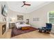 Spacious bedroom with a fireplace, TV, wood floors, and a decorative rug at 3988 Berlin Dr, Sarasota, FL 34233
