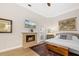 Bedroom with hardwood floors, fireplace, television, and comfortable seating at 3988 Berlin Dr, Sarasota, FL 34233