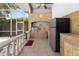 Well-equipped outdoor kitchen featuring stainless steel grill, fridge, and ample counter space at 3988 Berlin Dr, Sarasota, FL 34233