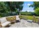 Inviting patio with brick flooring, balustrade, comfortable seating, and lush landscaping creating a relaxing outdoor space at 3988 Berlin Dr, Sarasota, FL 34233