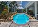 Stunning pool with rock accents, surrounded by a screened enclosure for year-round enjoyment at 3988 Berlin Dr, Sarasota, FL 34233