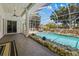 Spacious pool area with rock features, lush landscaping, and seamless indoor-outdoor transition at 3988 Berlin Dr, Sarasota, FL 34233