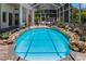 A stunning pool with rock features surrounded by tropical landscaping at 3988 Berlin Dr, Sarasota, FL 34233