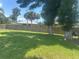 Spacious, grassy backyard enclosed by a wooden fence and dotted with mature trees at 4027 Allure Ln, North Port, FL 34287