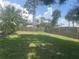 Large, grassy backyard enclosed by a wooden fence, offering privacy and space at 4027 Allure Ln, North Port, FL 34287