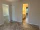 Bedroom with tile flooring showing view into closet and bathroom at 4027 Allure Ln, North Port, FL 34287