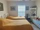 Bedroom with twin beds, tile flooring, and natural light at 4027 Allure Ln, North Port, FL 34287