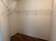 Walk-in closet features wood-look flooring and white shelving at 4027 Allure Ln, North Port, FL 34287
