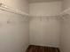 Walk-in closet features wood-look flooring and white shelving at 4027 Allure Ln, North Port, FL 34287