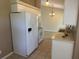 Kitchen featuring white appliances, tiled backsplash, and breakfast bar at 4027 Allure Ln, North Port, FL 34287